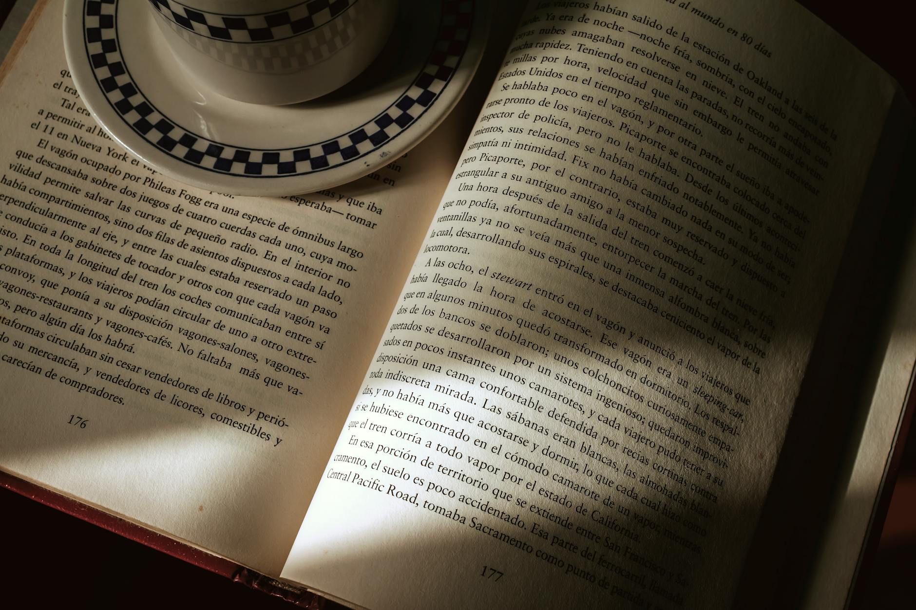 An open book with a coffee cup, capturing a serene reading atmosphere indoors.