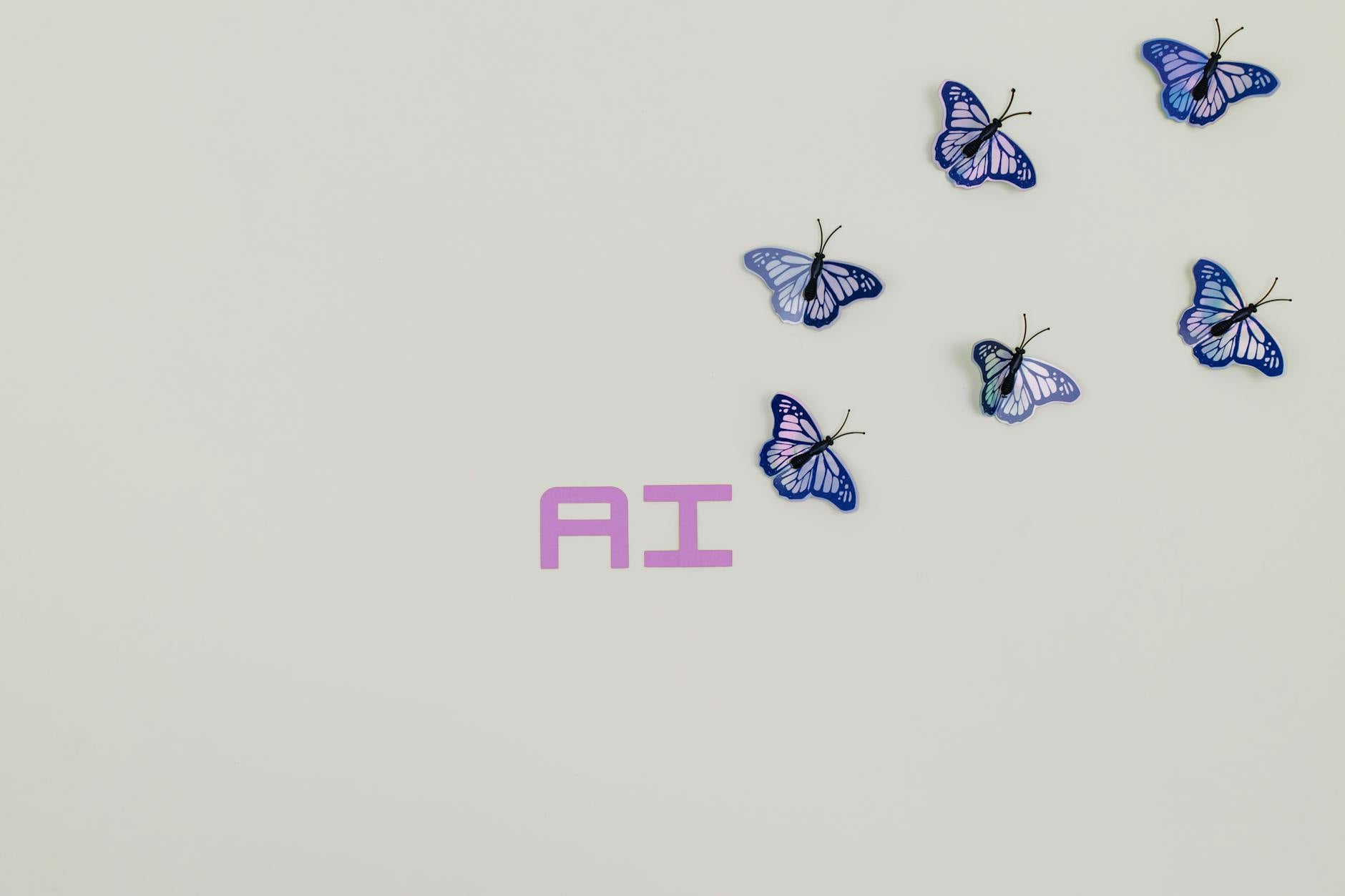 A creative image of butterflies flying over the word 'AI' on a soft pastel background, symbolizing innovation.